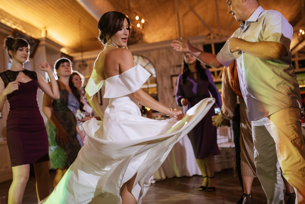 Bride joyfully dancing at her wedding reception, following the 30 5 minute rule for perfect timing.