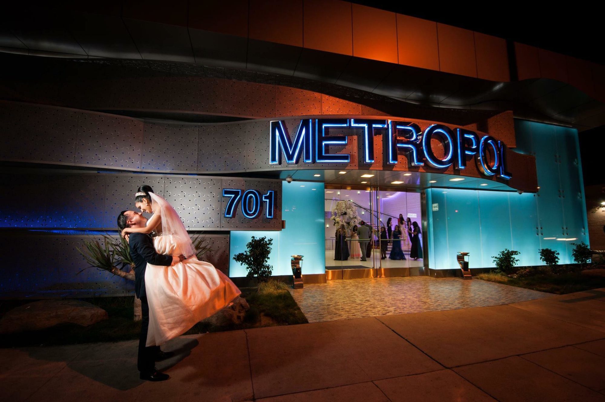 Where To Hold Your Wedding Ceremony In Los Angeles, CA Newlywed Couple Kissing In Front of Metropol Banquet In Los Angeles CA
