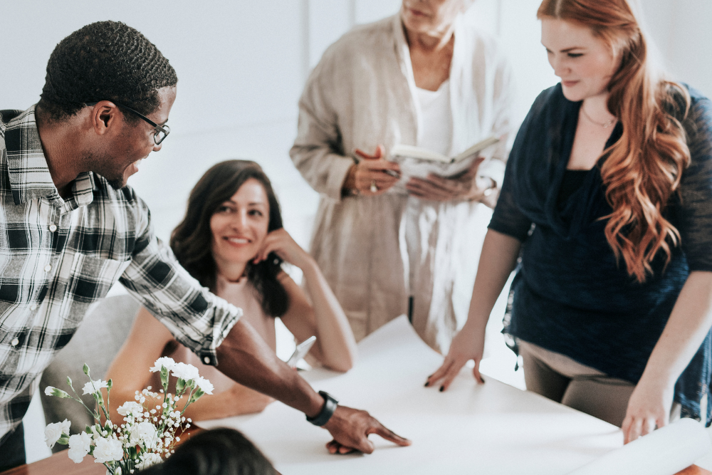 Team of planners discussing event schedule and applying the 30-5 minute rule for weddings to stay on time.