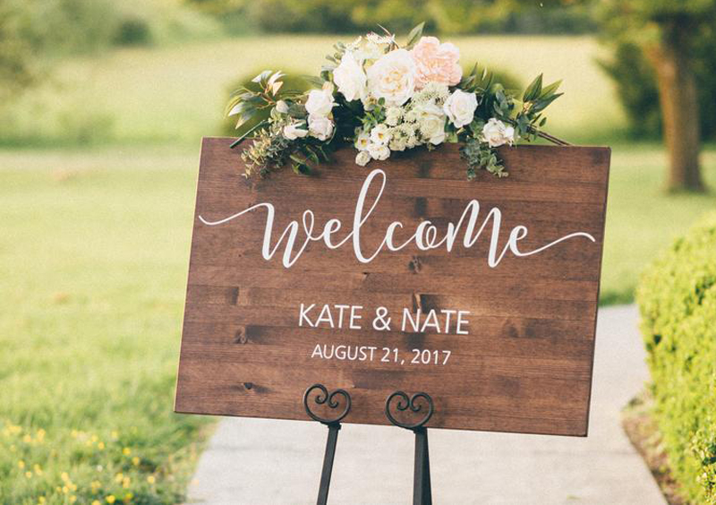 Stay Current! Here Are 11 Wedding Trends You’ll See Disappearing In 2020 Disappearing Wedding Trends - Faux Wedding Calligraphy On Wooden Welcome Sign