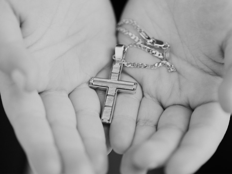 Important Steps To Planning A Christening Celebration Planning A Christening - Hands Holding Cross