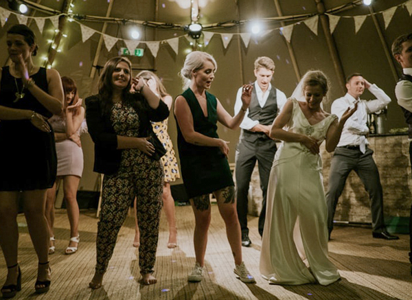 Bride And Guests Dancing At Wedding Celebration