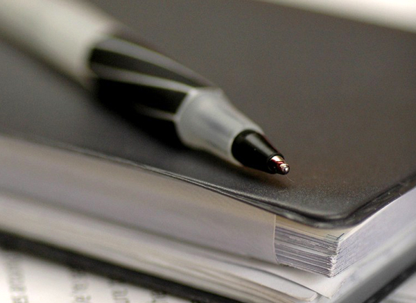 Close Up Of Pen Sitting On Binder