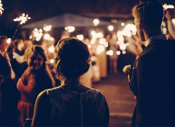 Guests At Wedding Celebration Holding Sparklers Outside