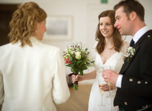 Don’t Forget To Do These Things At Your Wedding Celebration Bride And Groom Talking To A Woman At Their Wedding Celebration