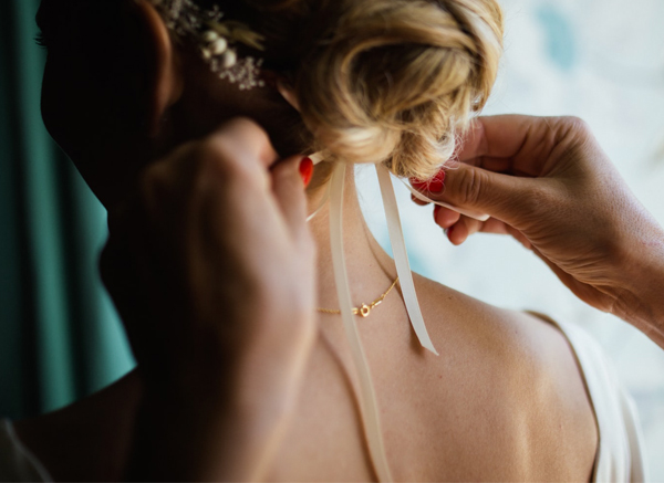 Bride Having Ribbon Tied In Hair