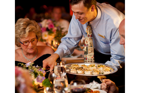 Wedding Reception Food Serving Styles - Family Style - Waiter Serving Woman Food From Platter